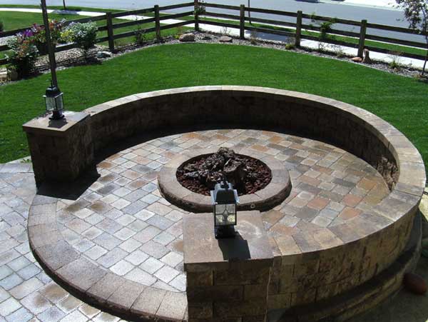Raised patio with fire pit and seating wall