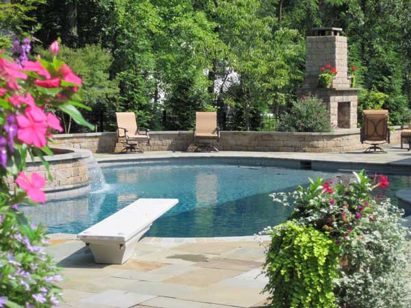 Backyard with pool with patterned retaining wall