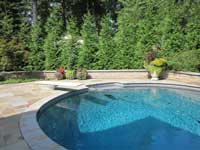 Below ground swimming pool with retaining wall
